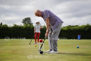 People play croquet at Chester Croquet Club in Westminster Park, following the outbreak of the coronavirus disease (COVID-19), Chester, Britain, June 12, 2020. REUTERS/Molly Darlington