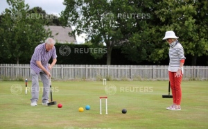 People play croquet at Chester Croquet Club in Westminster Park, following the outbreak of the coronavirus disease (COVID-19), Chester, Britain, June 12, 2020. REUTERS/Molly Darlington
