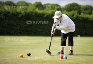 A woman plays croquet at Chester Croquet Club in Westminster Park, following the outbreak of the coronavirus disease (COVID-19), Chester, Britain, June 12, 2020. REUTERS/Molly Darlington